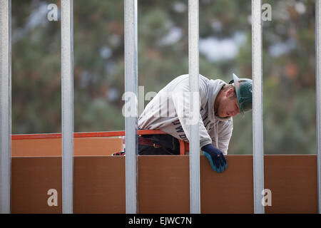 USA, Montana, Kalispell, Man working at construction site Stock Photo