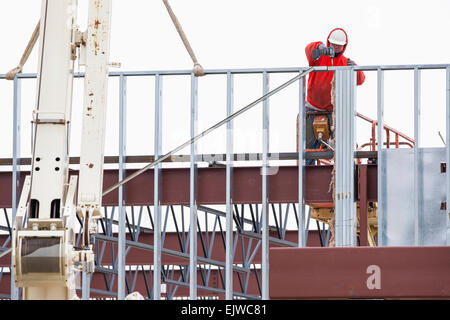 USA, Montana, Kalispell, Man working at construction site Stock Photo