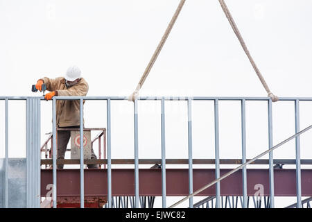 USA, Montana, Kalispell, Man working at construction site Stock Photo