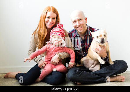 Family with baby son (2-3) and pug Stock Photo