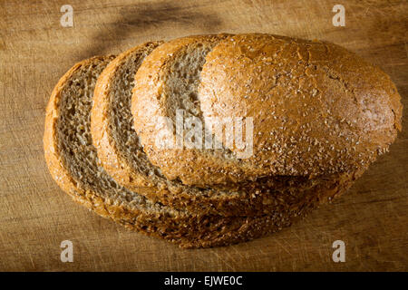 Rustic loaf. Shallow DoF, focus on the bread slices Stock Photo