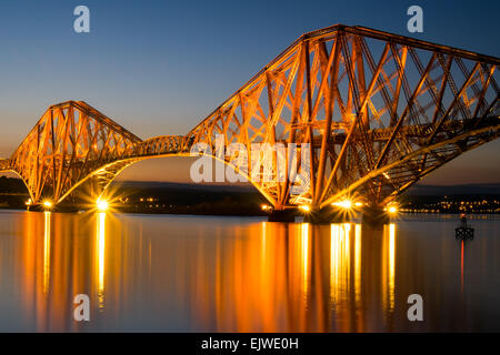 The famous Forth rail bridge illuminated at dawn Stock Photo