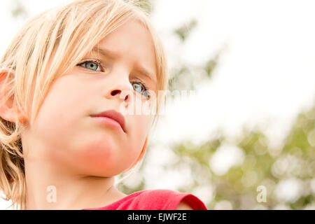 Pretty Little Girl Staring in Thought Outside Stock Photo