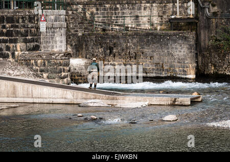 Fisherman on the river Serio while fishing. Typical trout fishing. Stock Photo