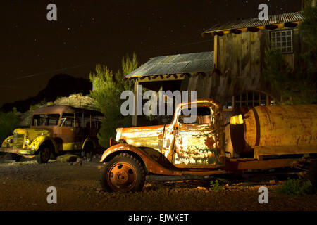 Abandoned truck and school bus in ghost town Stock Photo