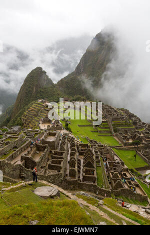 Peru, Machu Picchu, Early Morning Clouds.  Uña Picchu on left, Huayna Picchu in Clouds on Right. Stock Photo