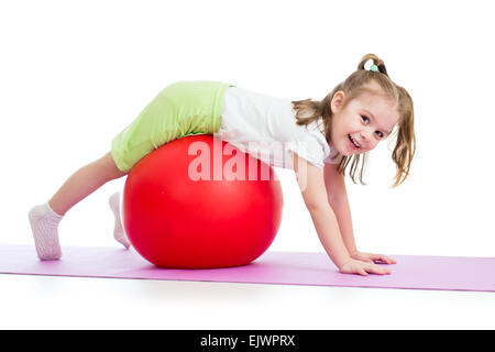 kid girl doing gymnastic exercise with fitball Stock Photo