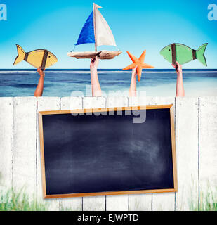 Empty Black Board on White Fence with Hands Holding Objects Stock Photo