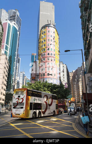 A bus on the streets of Hong Kong Wan Chai area. Hong Kong has a very efficient and inexpensive mass transit system. Stock Photo