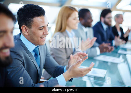 Happy business people applauding to speaker at seminar Stock Photo