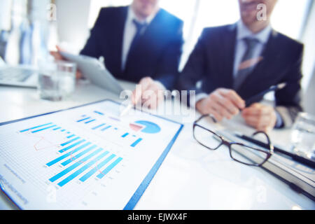 Close-up of businessmen discussing document at meeting Stock Photo