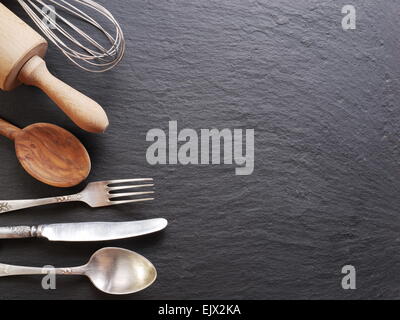 Cooking utensils on a dark gray background. Stock Photo