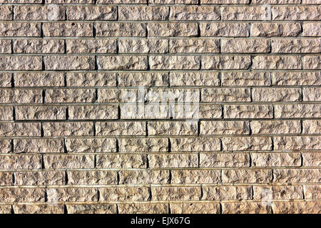 Piece of a wall from chipped beaten yellow bricks background texture Stock Photo