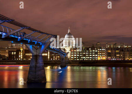 Night shot of the illuminated St Paul's Cathedral, London, with the Millennium Bridge across the River Thames in the foreground Stock Photo