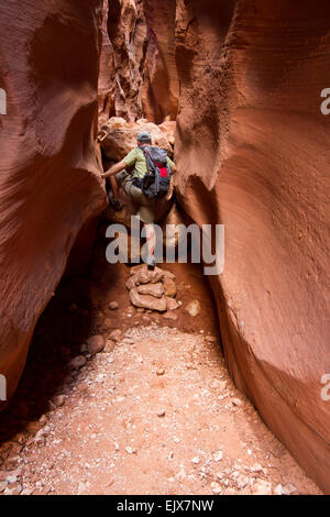 Hiker in a slot canyon in Utah, USA Stock Photo