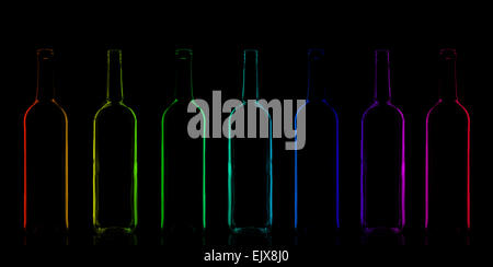 Row of rainbow colored bottles Stock Photo