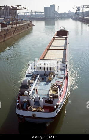 Barge reversing out of port Stock Photo