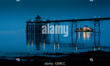 The Paddle Steamer Waverley leaves Clevedon Pier late one evening, taking day trippers home across the Bristol Channel. Stock Photo