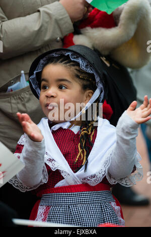 A young little girl child  in traditional Welsh costume national dress taking part in the St David's Day Parade and Celebrations, Wrexham, 1 March 2015 Stock Photo