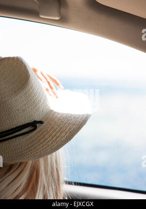 Back View of Woman Looking at the Ocean from Inside Car