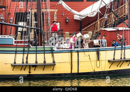 Tourists throwing tea chests from Beaver, replica of one of Boston Tea Party ships, Boston Tea Party Museum, Boston, USA Stock Photo