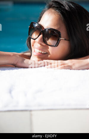 Woman Resting Face on Swimming Pool Edge Smiling