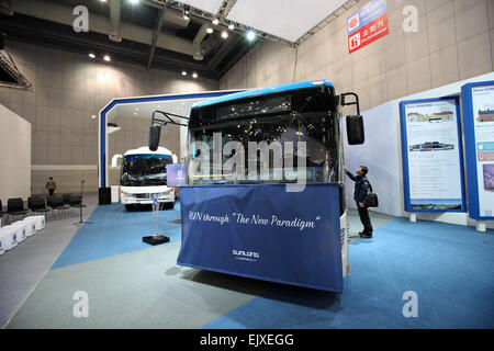 (150402) -- SEOUL, April 2, 2015 (Xinhua) -- A visitor looks at a Shanghai Sunlong Bus at the Seoul Motor Show in Seoul, South Korea, April 2, 2015. Shanghai Sunlong Bus, a Chinese automaker, showcases its strategic model CT Boo for the first time at this year's Seoul Motor Show. (Xinhua/Seongbin Kang) Stock Photo