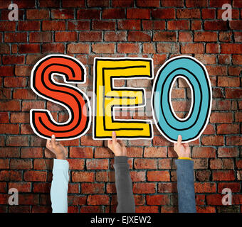 Multiethnic Group of Hands Holding Letter SEO Stock Photo