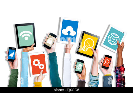 Hands Holding Digital Devices with Various Symbols Stock Photo