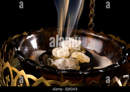 Closeup of real smoking church incense on burning charcoal Stock Photo