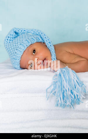 Newborn african baby with knitted blue bonnet Stock Photo