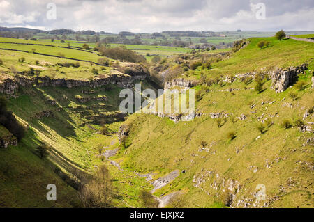 The upper section of Lathkill Dale with view toward the village of Monyash. A sunny spring day in the Peak District. Stock Photo