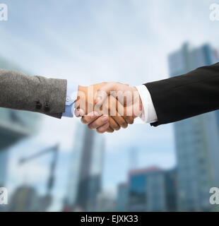 businessman and businesswoman shaking hands Stock Photo