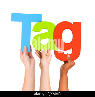 Multi-Ethnic Group of Diverse People Holding Letters To Form A Word Tag For Tag Cloud Stock Photo