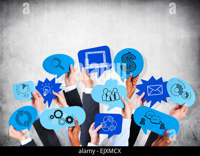 Business people's hands holding the speech bubble with business theme. Stock Photo