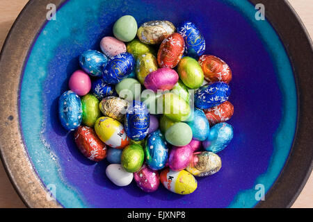Mini eggs in a blue bowl. Stock Photo