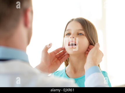 male doctor checks little girl lymph nodes Stock Photo