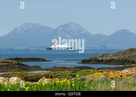 caledonian macbrayne car ferry mv finlaggan from islay en route to kennacraig viewed from shore on gigha with paps of jura Stock Photo