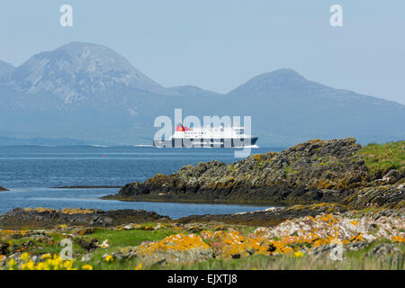 caledonian macbrayne car ferry mv finlaggan from islay en route to kennacraig viewed from shore on gigha with paps of jura Stock Photo