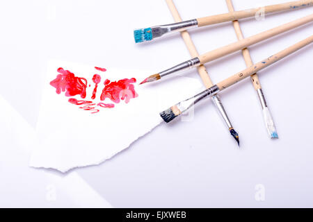 Red spot and ordered paintbrushes Stock Photo