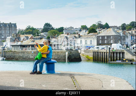 A couple in their thirties taking a selfie at Padstow, Cornwall. Stock Photo