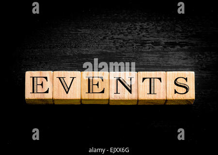 Word Events. Wooden small cubes with letters isolated on black background.Concept image. Stock Photo