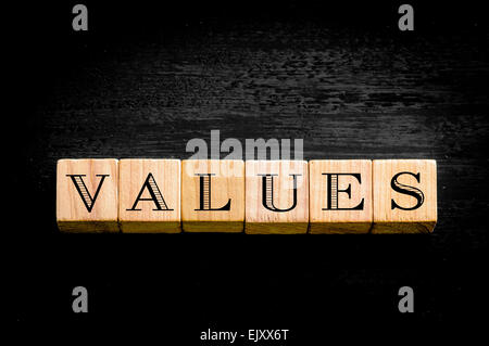 Word Values. Wooden small cubes with letters isolated on black background.Concept image. Stock Photo
