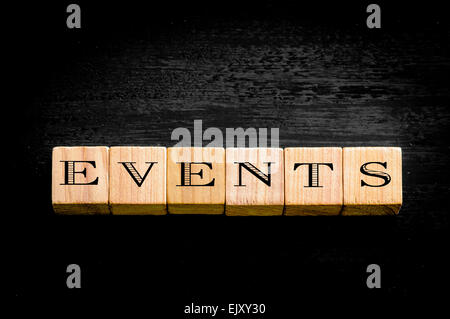 Word Events. Wooden small cubes with letters isolated on black background.Concept image. Stock Photo