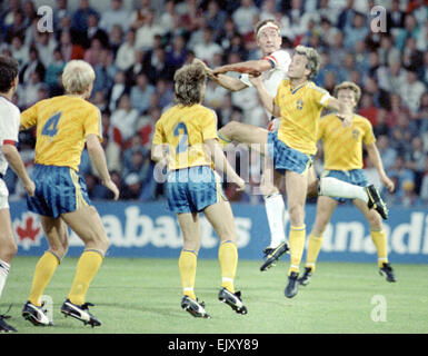 6 September 1989, Sweden v England. Terry Butcher seen here in defence during Englands vital World Cup qualifier in Sweden, Butcher suffered a deep cut to his forehead early in the game but carried on after some impromptu stitches were inserted by the physiotherapist and his head swathed in bandages. His constant heading of the ball - unavoidable when playing in the centre of defence - disintegrated the bandages and reopened the cut to the extent that his white England shirt was entirely red by the end of the game. Stock Photo