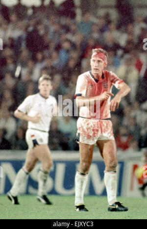 6 September 1989, Sweden v England. Terry Butcher indicates to the referee to blow his whistle close to he end of Englands vital World Cup qualifier in Sweden, Butcher suffered a deep cut to his forehead early in the game but carried on after some impromptu stitches were inserted by the physiotherapist and his head swathed in bandages. His constant heading of the ball - unavoidable when playing in the centre of defence - disintegrated the bandages and reopened the cut to the extent that his white England shirt was entirely red by the end of the game. Stock Photo