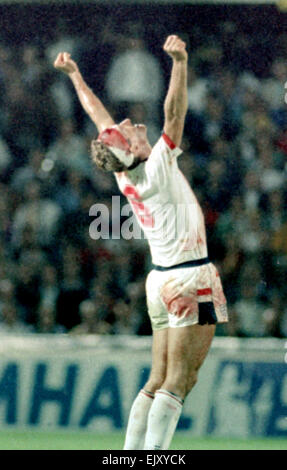 6 September 1989, Sweden v England. Terry Butcher celebrates at the end of Englands vital World Cup qualifier in Sweden, Butcher suffered a deep cut to his forehead early in the game but carried on after some impromptu stitches were inserted by the physiotherapist and his head swathed in bandages. His constant heading of the ball - unavoidable when playing in the centre of defence - disintegrated the bandages and reopened the cut to the extent that his white England shirt was entirely red by the end of the game. Stock Photo