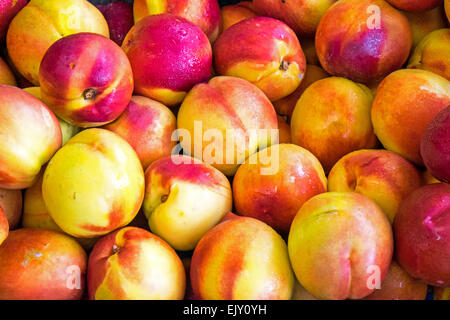 Fresh ripe nectarines seen on a market Stock Photo
