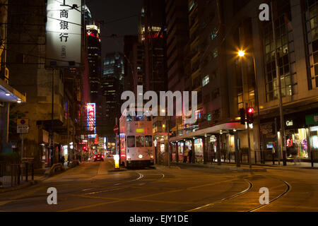 Night shot of the Hong Kong Central HK Victorian Tram System. Tram in station in this wide angle shot showing the empty street. Stock Photo