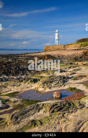 Black Nore Lighthouse near Portishead in North Somerset.  Captured at low tide from the rocky shoreline of the Severn Estuary. Stock Photo